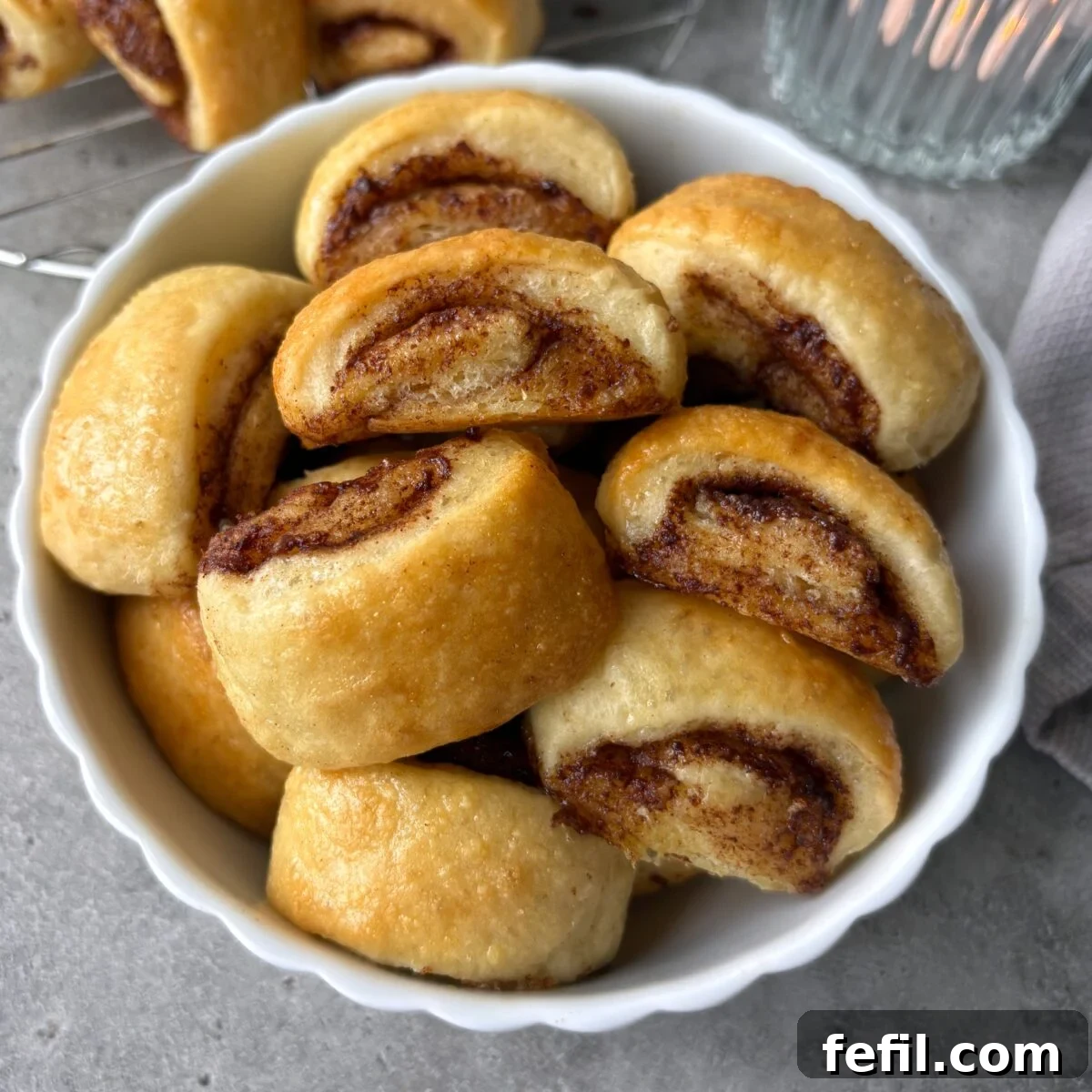 Mini Cinnamon Roll Bites with Cream Cheese Glaze 2 Mini cinnamon rolls in a bowl.