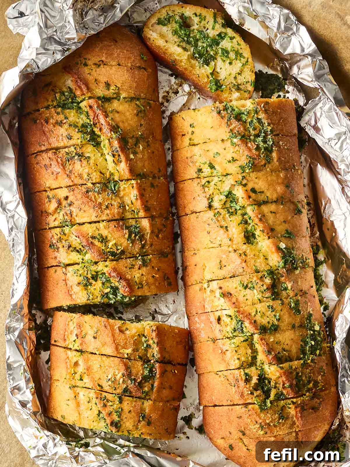 Perfect Crispy Garlic Bread with Herbed Butter 2 A foil package with homemade garlic bread inside.