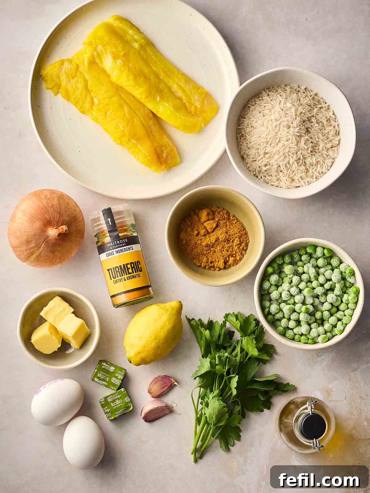 Classic Kedgeree: Smoked Fish, Rice & Curried Eggs 4 The ingredients for making Kedgeree laid out on a white surface.