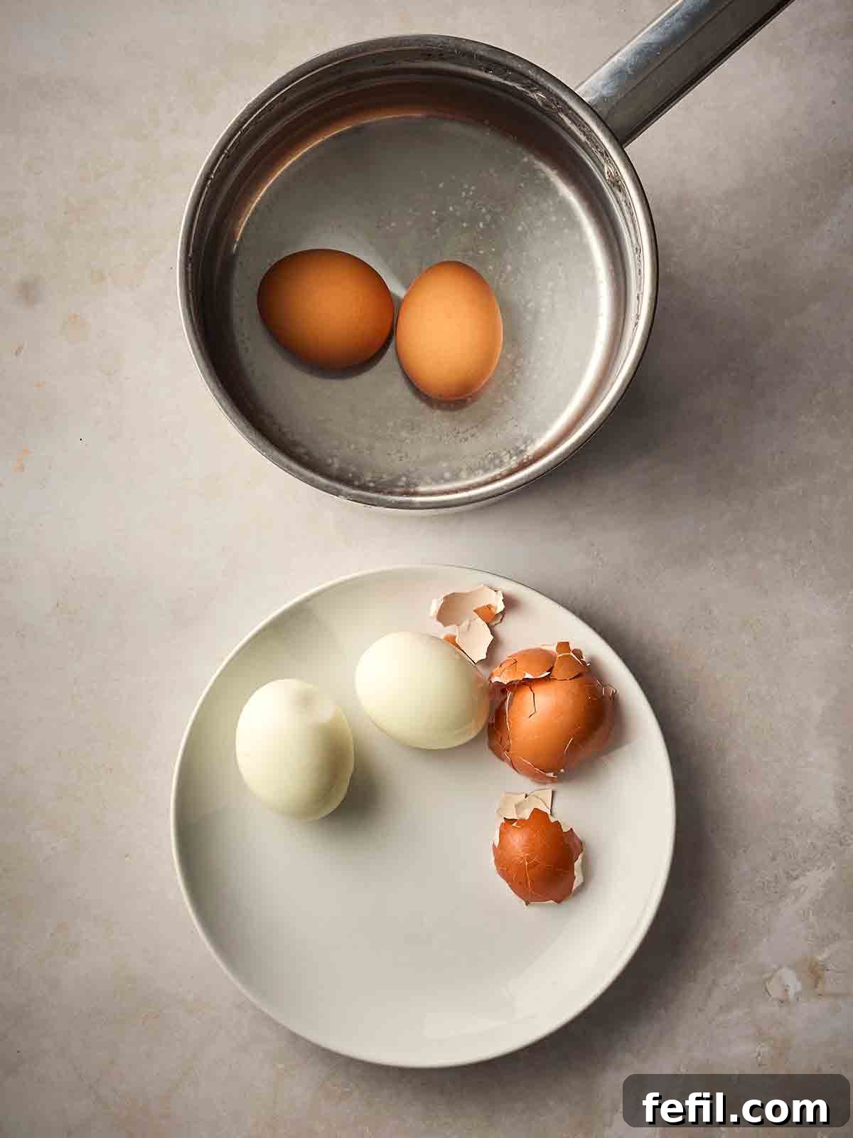 Classic Kedgeree: Smoked Fish, Rice & Curried Eggs 5 Two boiled eggs in a pan with a plate to side of peeled boiled eggs.