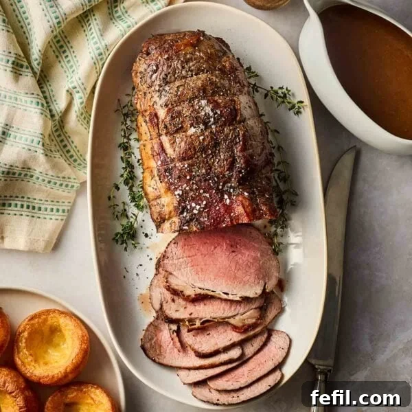 How to Make Crispy Pork Belly with Perfect Crackling Skin 5 A platter of cooked roast beef, sliced and ready to serve on a table for dinner.
